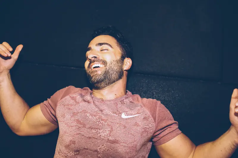 A LiFT member laughing between sets on the gym floor